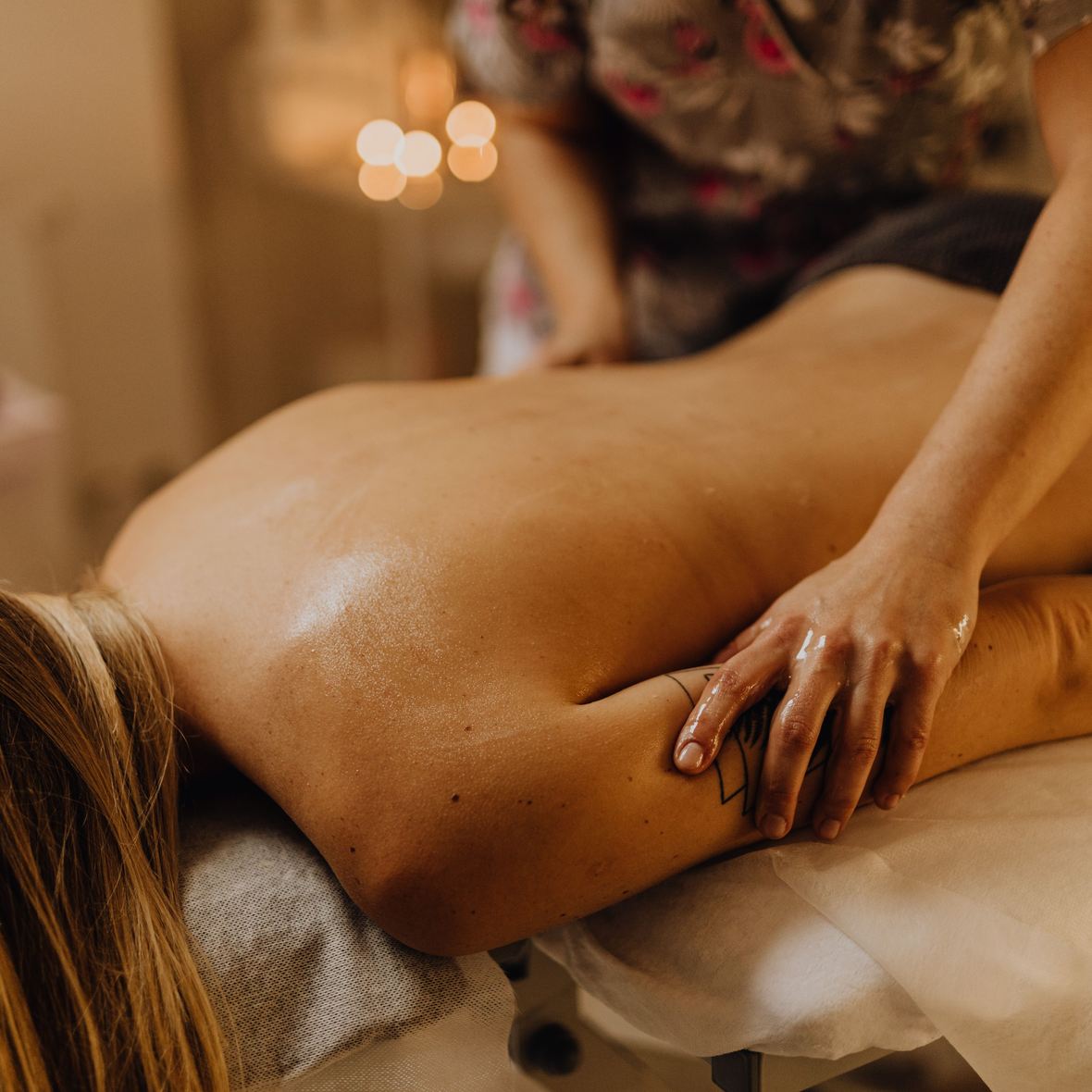 Long, flowing strokes along a client's back during a Swedish massage
